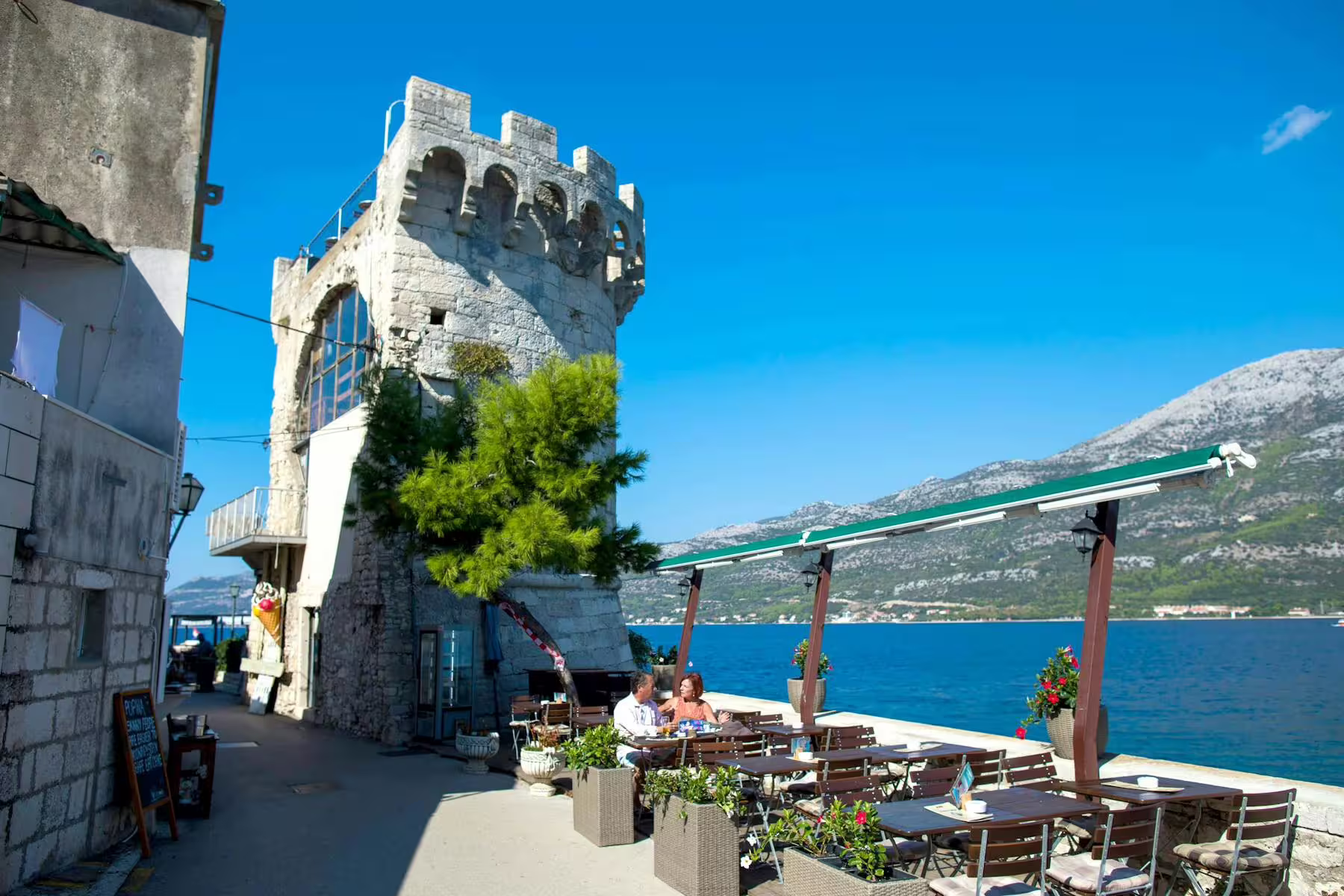 Seaside cafe by Korcula stone tower with Adriatic views on Legends of Peljesac & Korcula tour from Dubrovnik