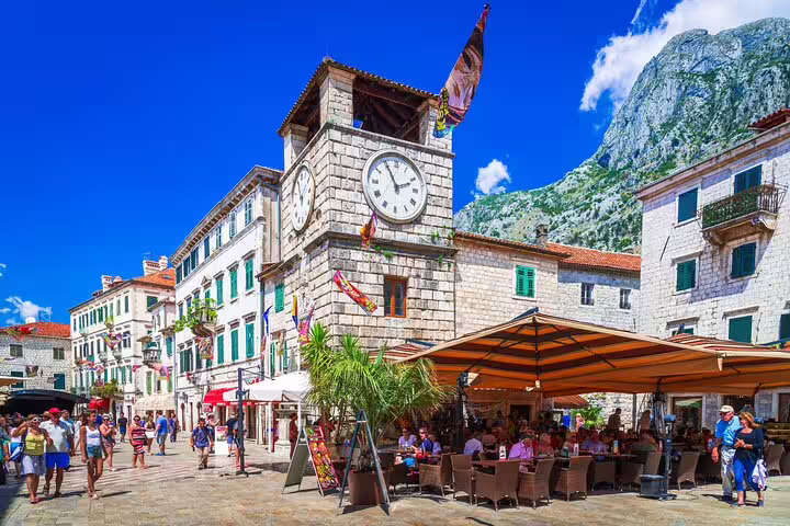Kotor Old Town clock tower square café scene, popular stop on Dubrovnik to Budva private car tour