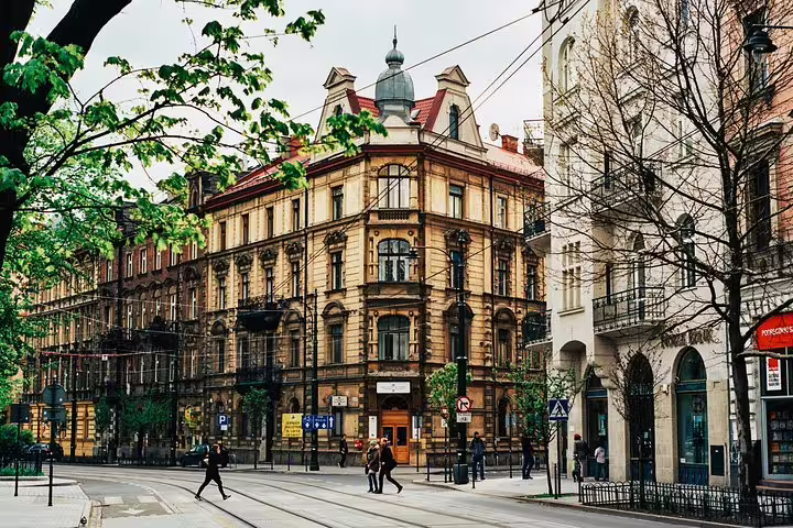 Krakow city center crossroads with ornate townhouse facades, ideal stop on a private half-day Krakow tour