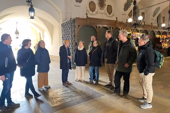Group exploring Krakow's famous Cloth Hall on a guided walking tour of the enchanting Old City.