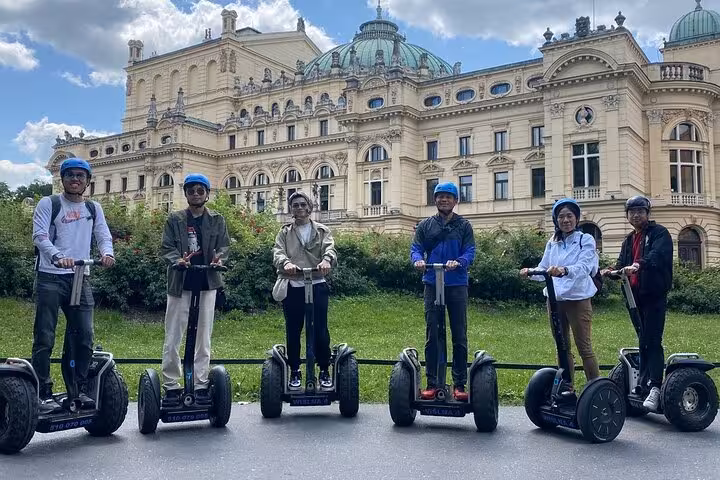 Group enjoying a Segway tour in front of the historic Krakow Old Town architecture, perfect for exploring Kazimierz.