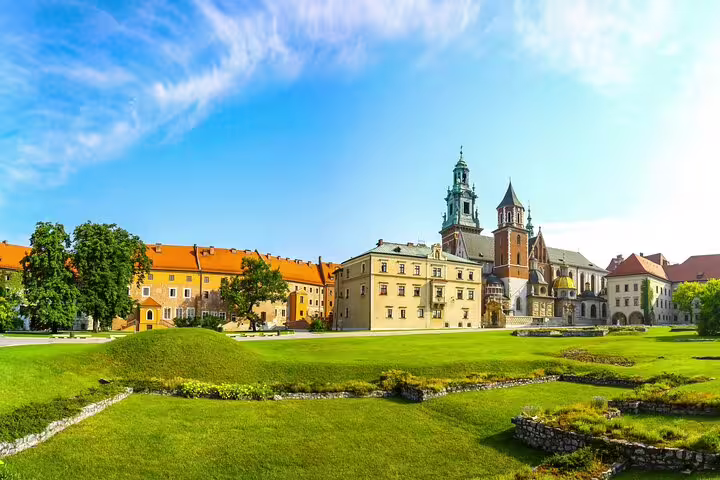 Wawel Castle and Cathedral with lush green gardens in Krakow, Poland on a sunny day