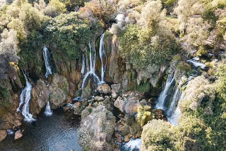 Aerial view of Kravice Waterfalls near Mostar, cascading into a turquoise pool on a day trip tour