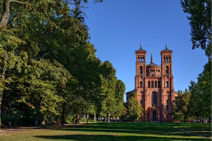 Red brick church with twin towers viewed from Volkspark Hasenheide park in Kreuzberg Berlin