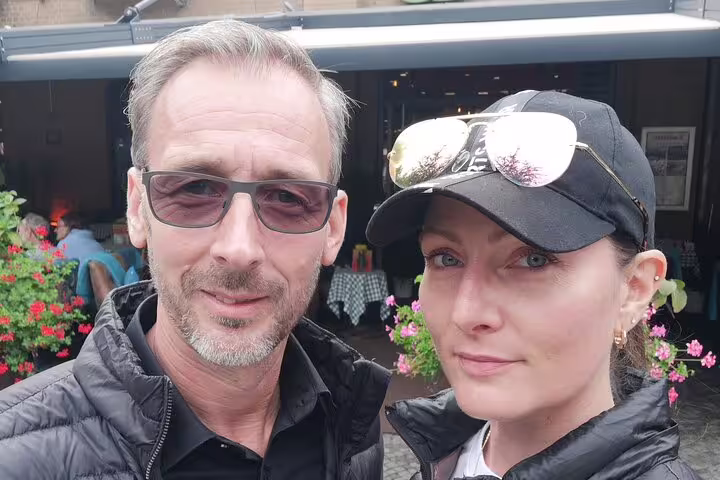Couple posing for selfie outdoors near café with flowers in Kreuzberg Berlin