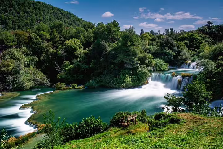 Panoramic Krka National Park waterfalls and turquoise lake, Croatia, popular stop on Krka day trip tour