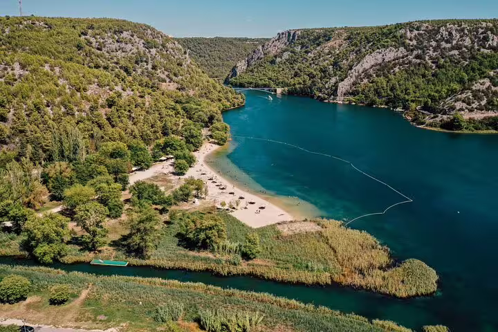 Aerial view of Krka River lake and swimming area on Krka Waterfalls tour with boat cruise through the canyon
