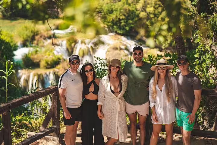 Group photo at Krka Waterfalls viewpoint on scheduled Krka tour from Split with food and wine tasting