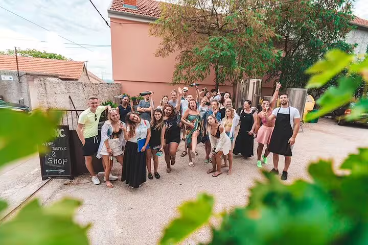 Happy group at Dalmatian winery stop on Krka Waterfalls food and wine tasting tour near Split, Croatia