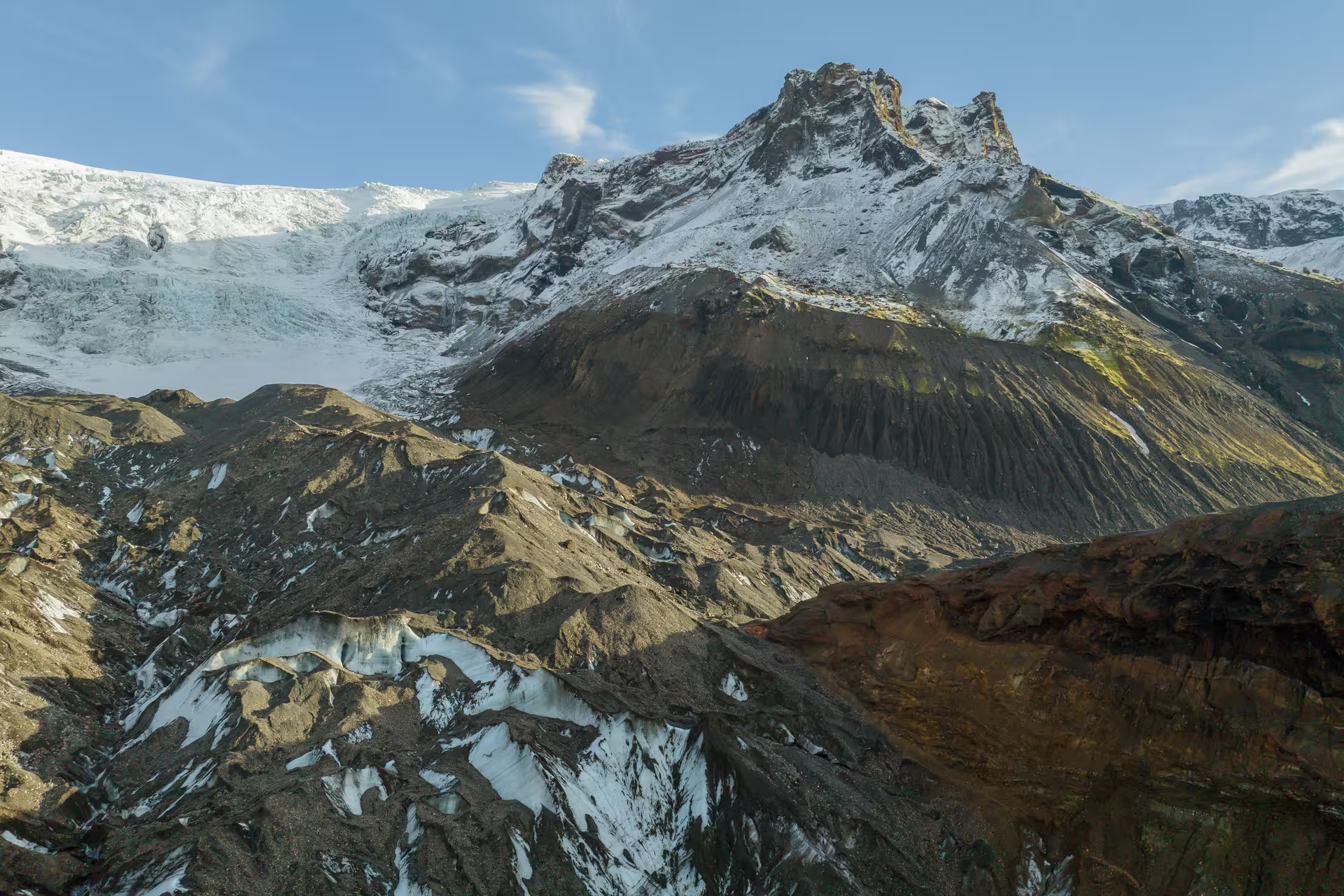 Snow-capped Krossarjokull Glacier with dramatic volcanic rocky peaks on an Iceland glacier day trip tour