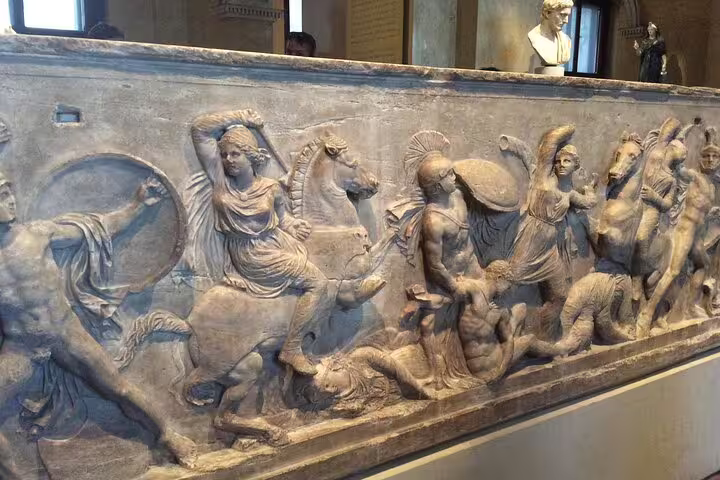 Intricate marble relief showcasing dynamic battle scenes at the Kunsthistorisches Museum, highlighting historical artistry.