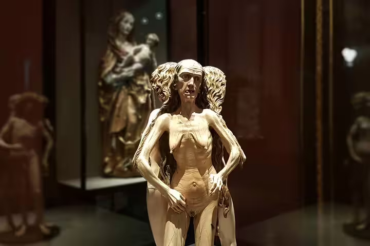 Unique wooden sculpture of a multi-faced figure at the Kunsthistorisches Museum, emphasizing artistic beauty and complexity.