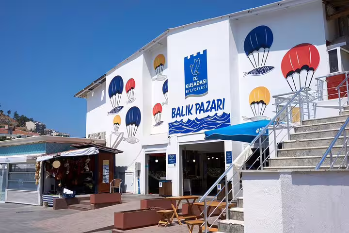 Kusadasi Belediyesi Balik Pazari fish market building with colorful hot air balloon murals, Turkey