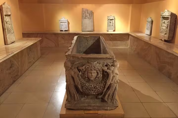 Archaeology museum exhibit with carved Roman sarcophagus, cultural highlight on 4-day small-group tour Kusadasi to Istanbul