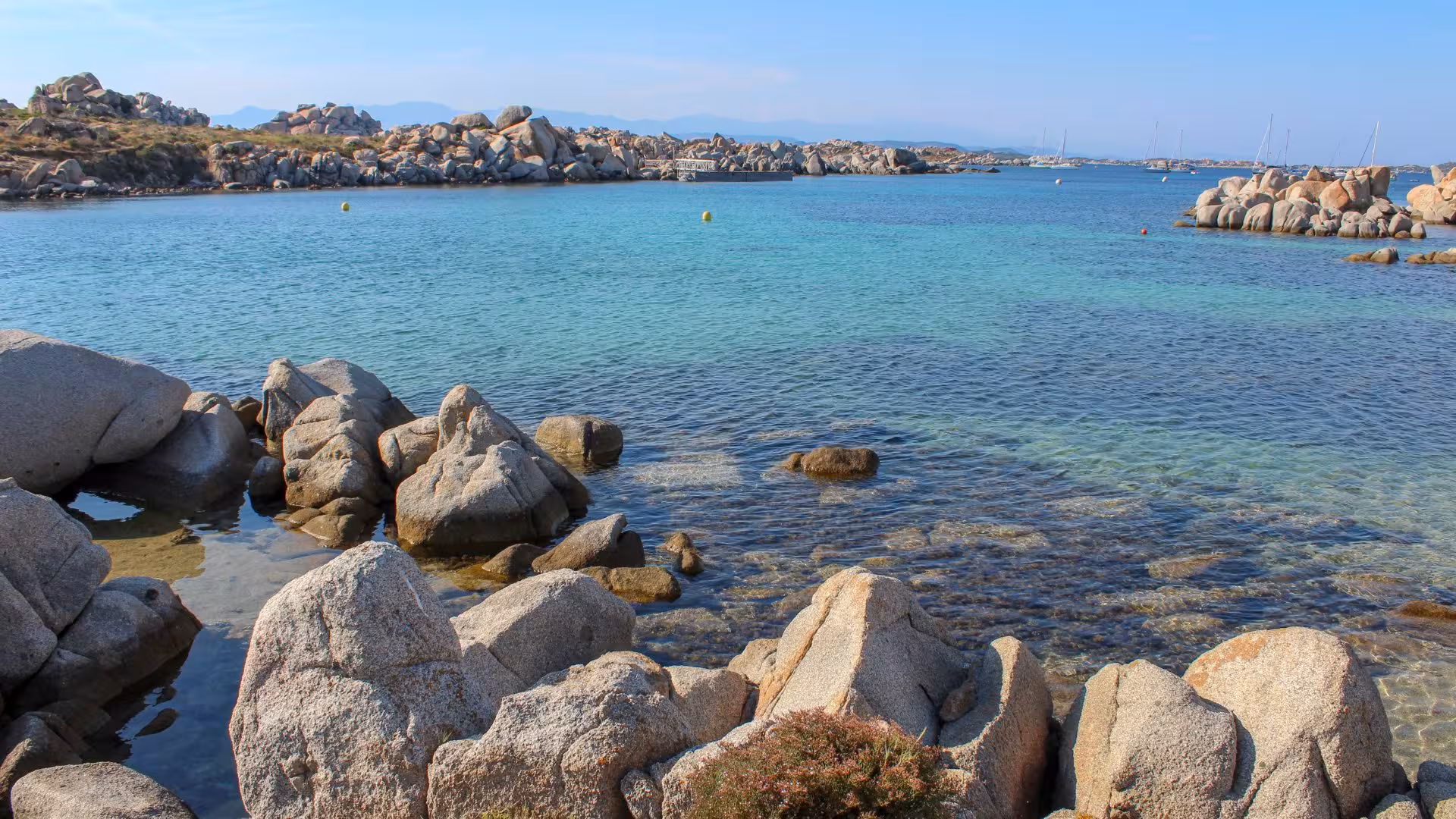 Crystal-clear waters and rugged rocks of La Maddalena Archipelago, ideal for Corsica boat tours.