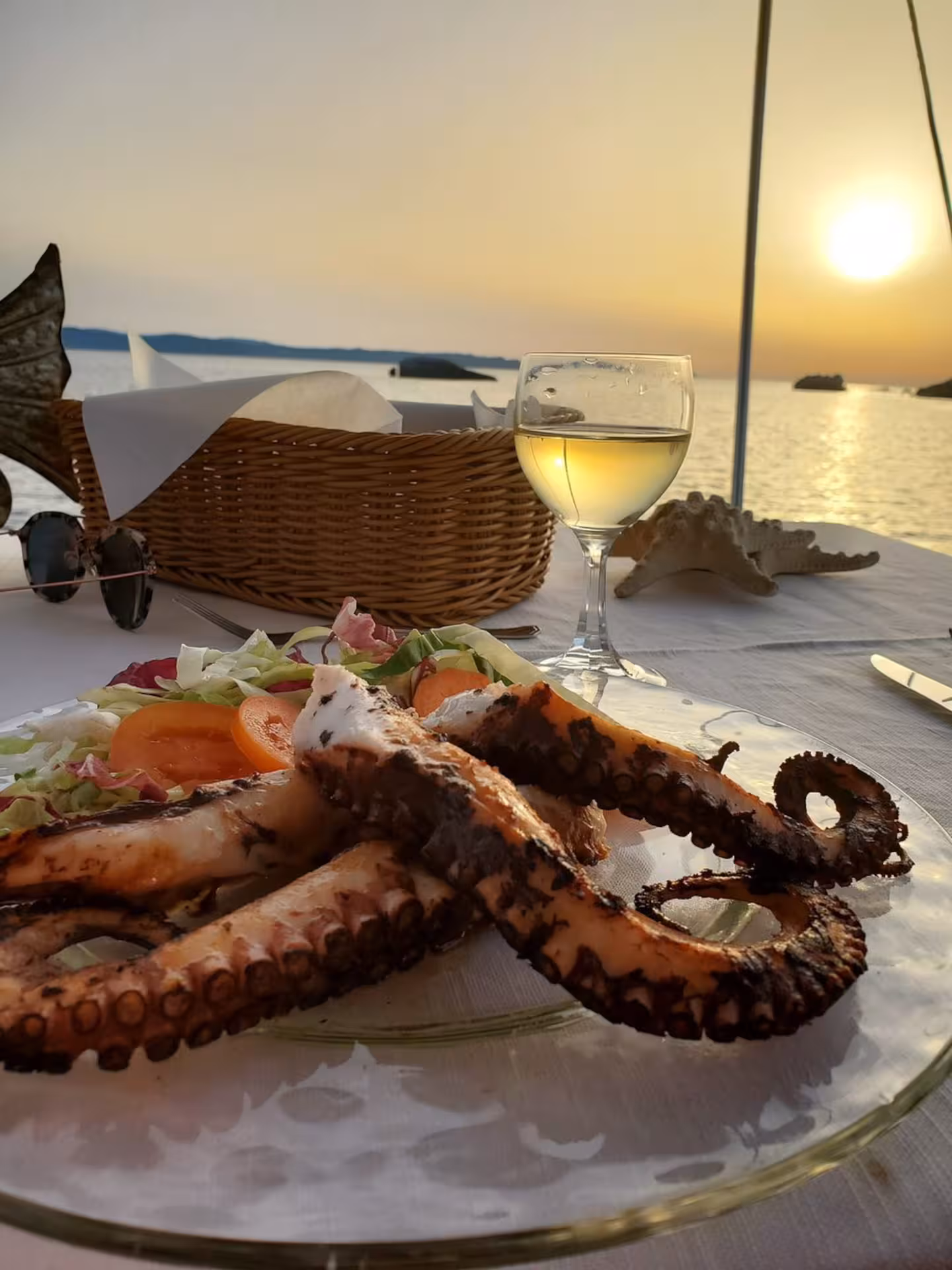 Savor grilled octopus and wine with a stunning sunset view on a La Maddalena Archipelago private tour.