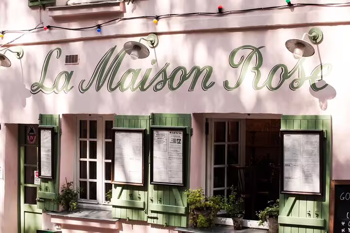La Maison Rose restaurant pink facade with green shutters in Montmartre Paris