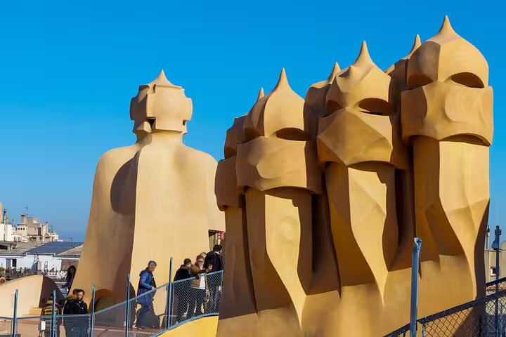 Visitors walk among the surreal warrior chimneys on La Pedrera rooftop during a guided morning tour of Gaudí’s modernist masterpiece
