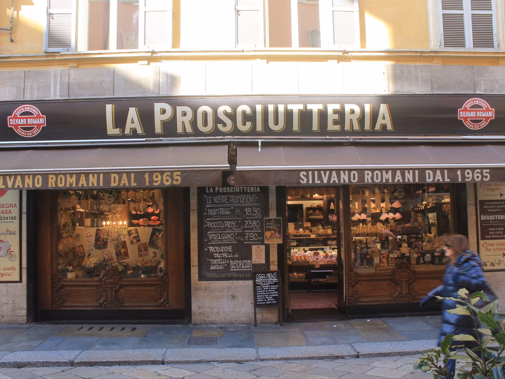Exterior view of La Prosciutteria in Parma, a traditional deli offering authentic Italian meats and local specialties.