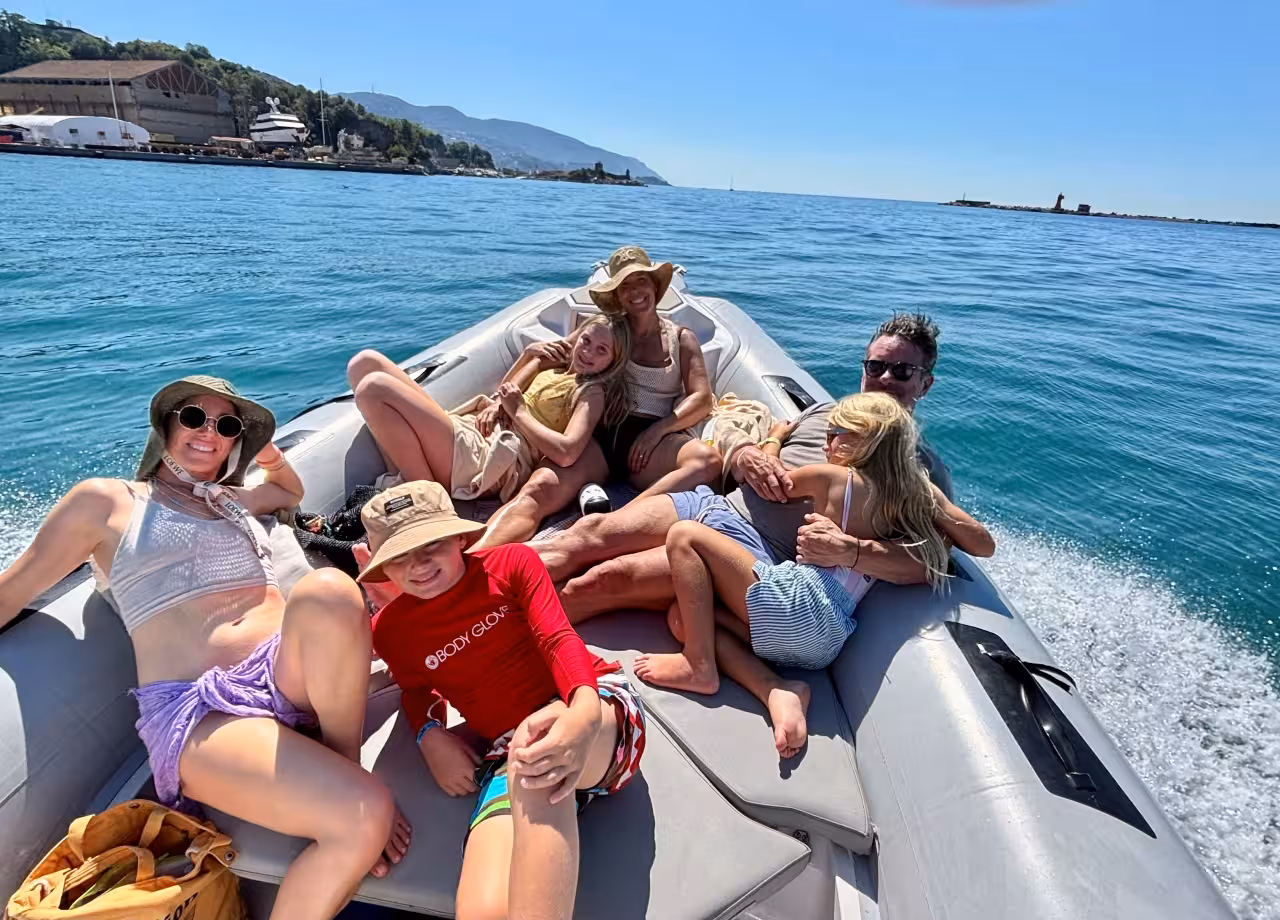 Family relaxing on a RIB boat leaving La Spezia harbor on a full-day Cinque Terre boat excursion