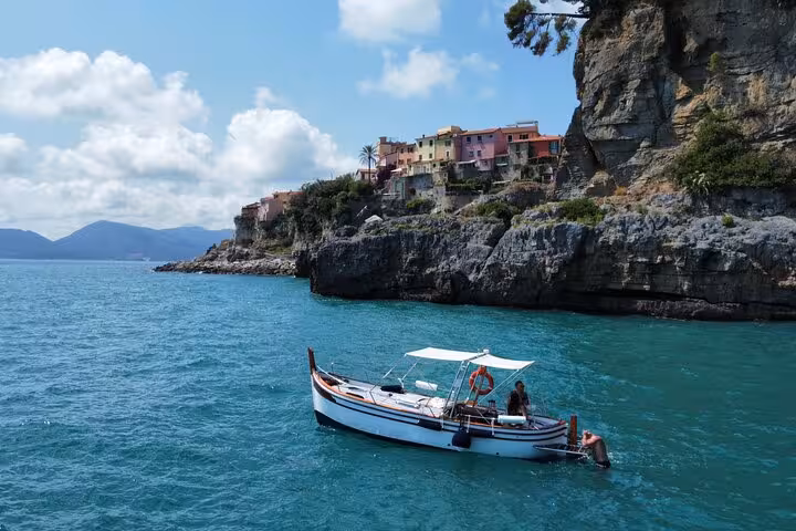 Vibrant sunset over calm waters as seen from a boat in Golfo Dei Poeti, La Spezia, highlighting the picturesque seascape.