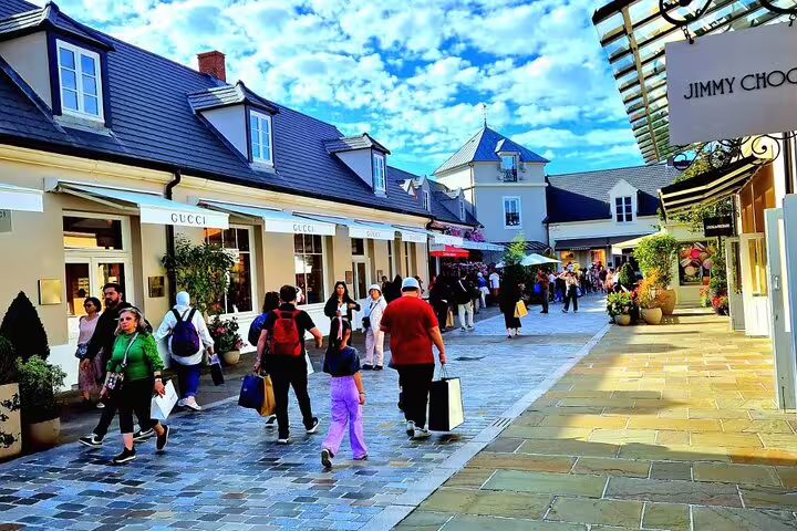 Crowds shopping Gucci and Jimmy Choo at La Vallée Village, reached by round-trip private transfer from Paris for 1-3