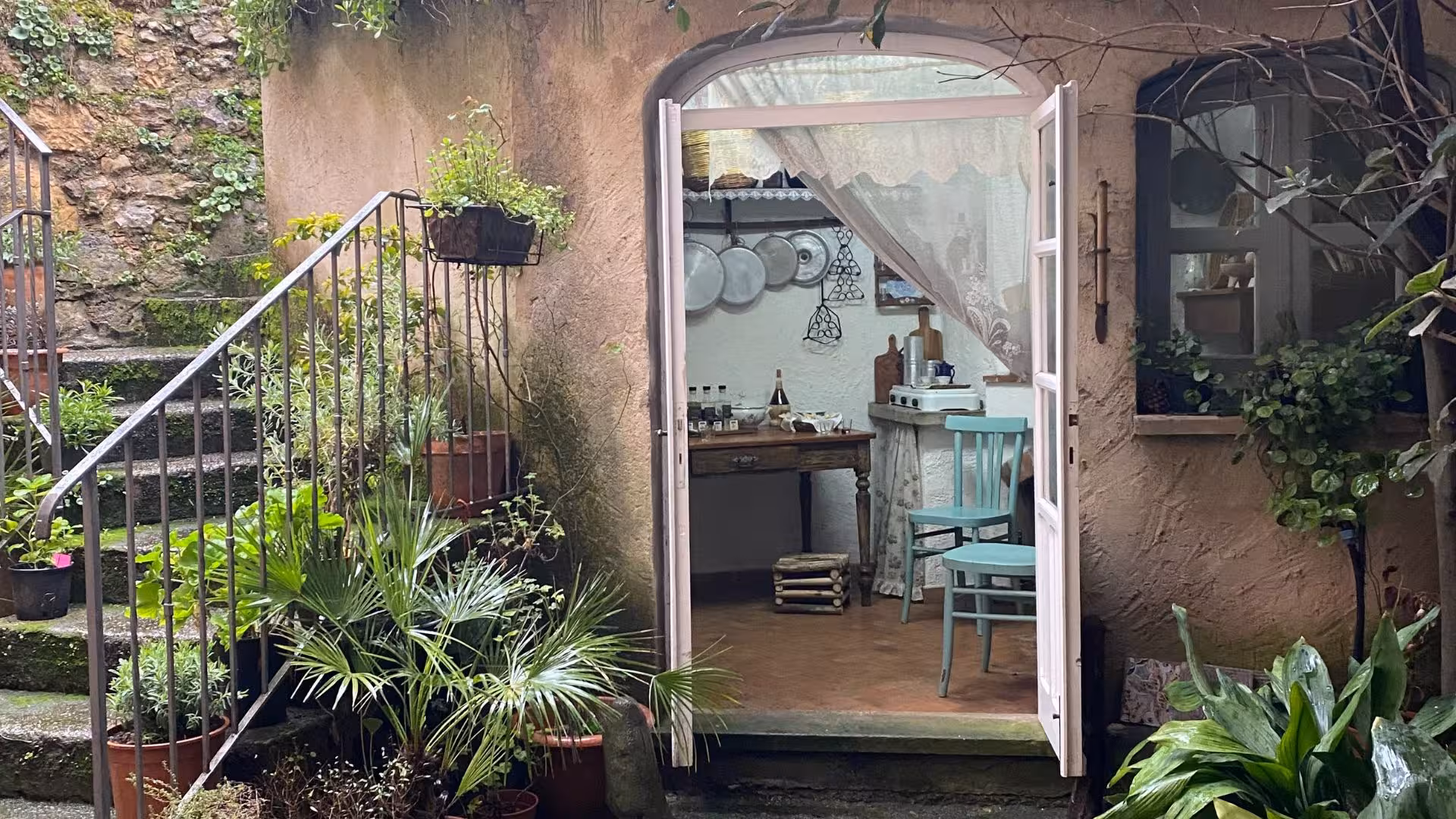 Charming rustic kitchen entrance with vintage decor, setting for Laconi's chocolate and liqueur tasting experience.