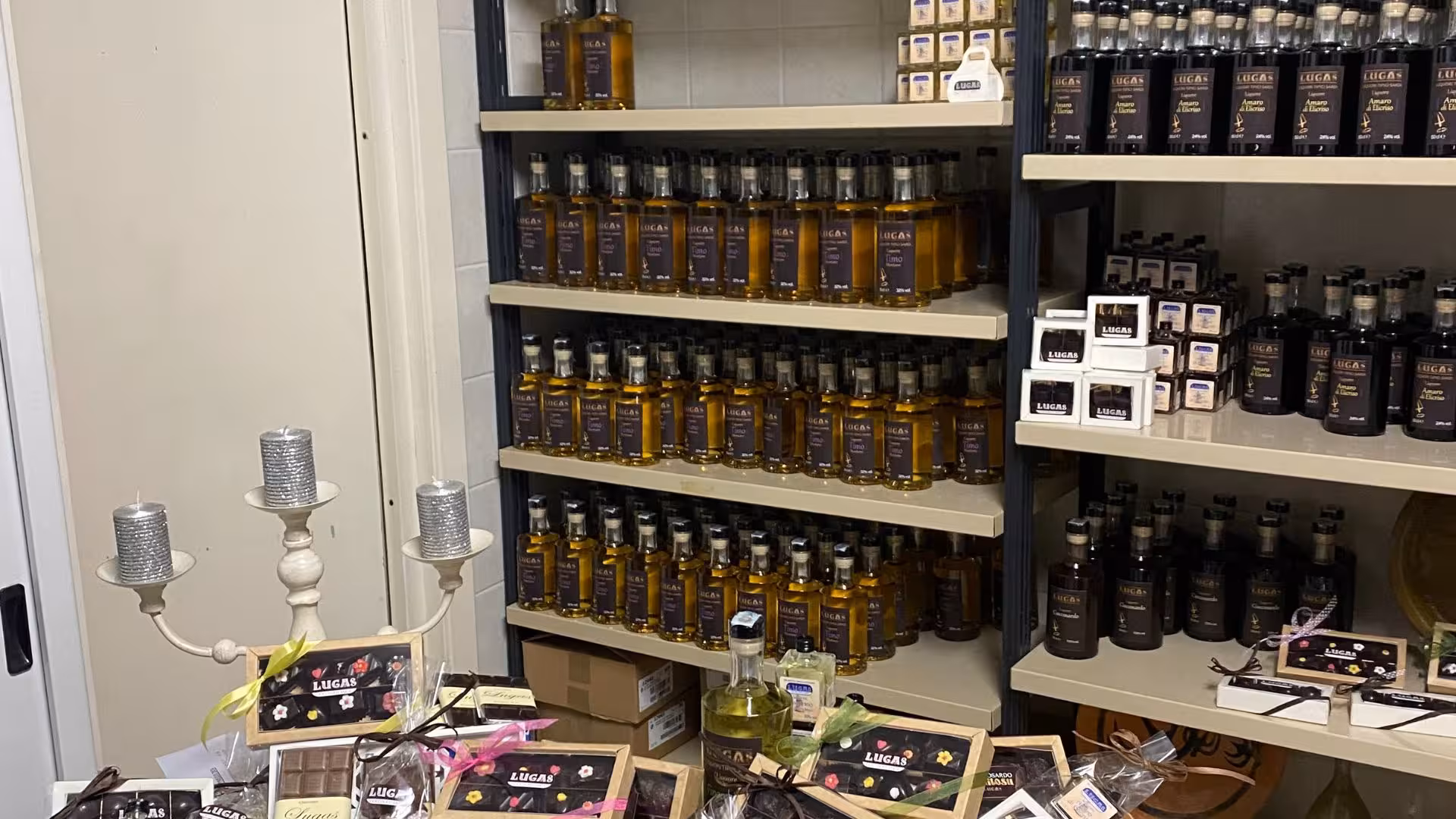 Shelves stacked with traditional liqueur bottles, perfect for Laconi tasting tour enthusiasts.
