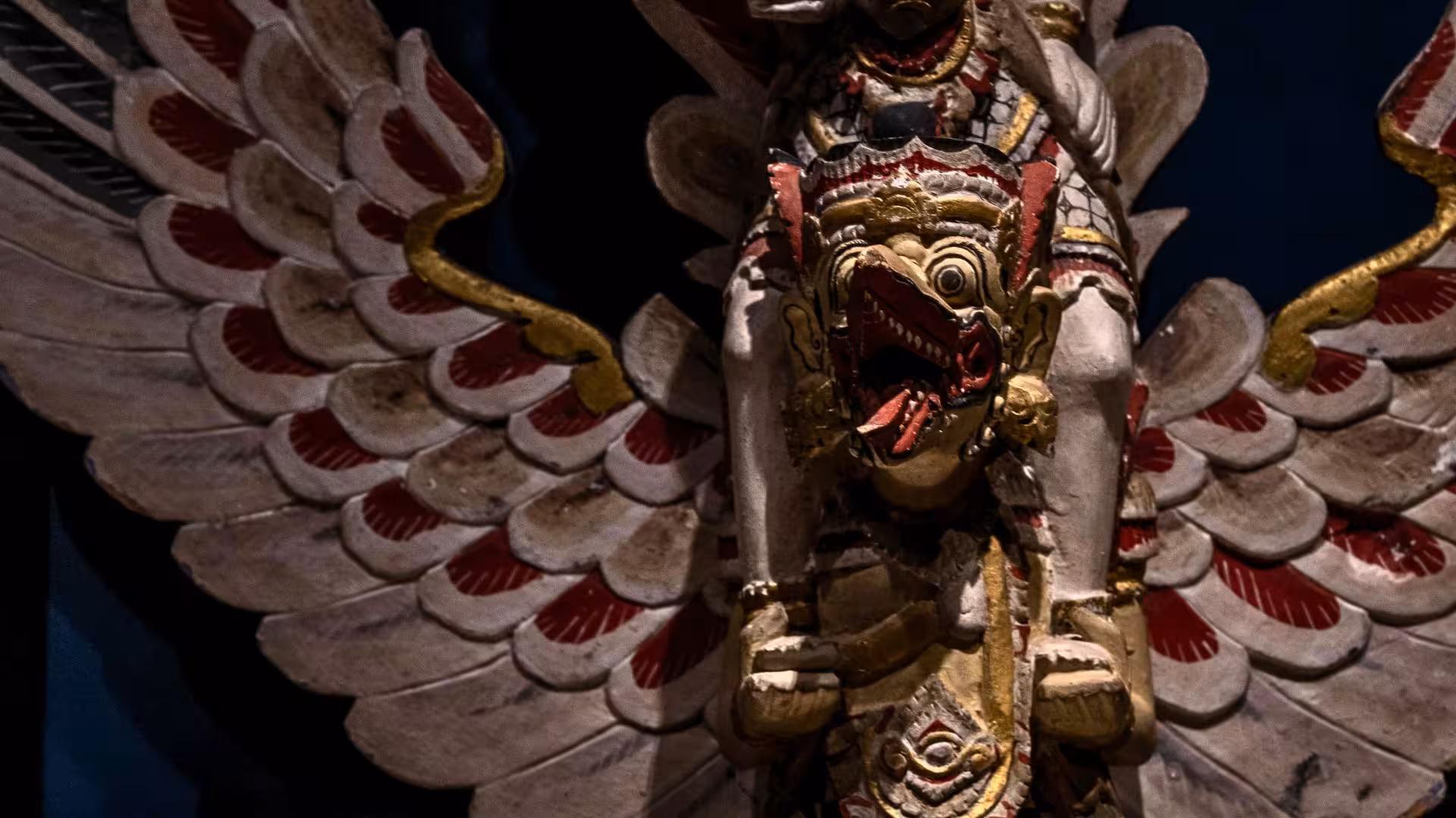 Intricate wooden sculpture of a mythical creature displayed in Laconi's cultural heritage tour.
