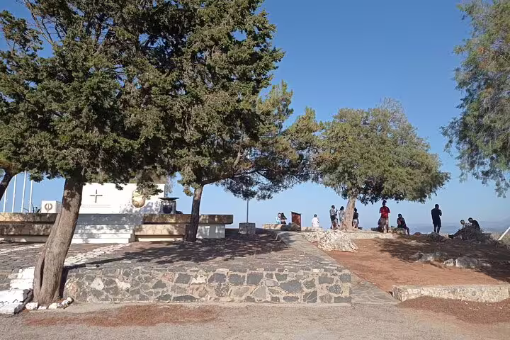 Tourists explore the tranquil grounds of Lady of the Angels Monastery with panoramic views in Falasarna beach area.