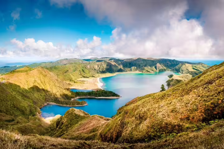 Breathtaking view of Lagoa do Fogo's azure waters surrounded by lush green hills on São Miguel Island, Azores.