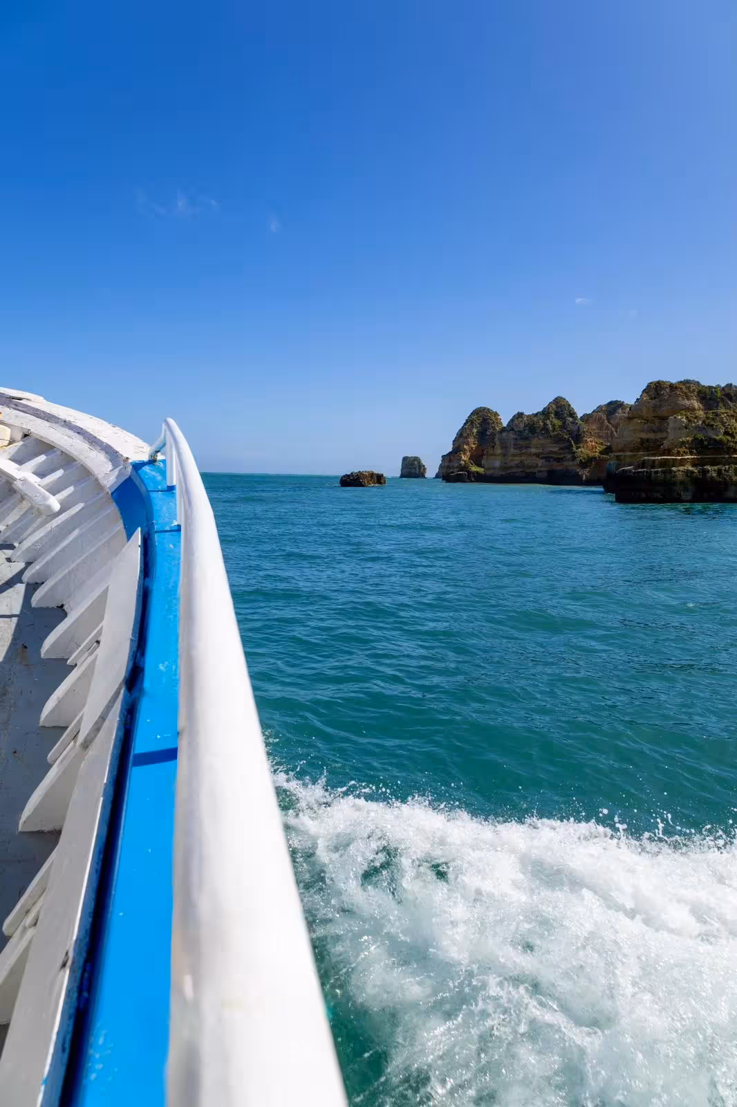 View from a Lagos boat tour passing dramatic Algarve rock formations and turquoise sea caves