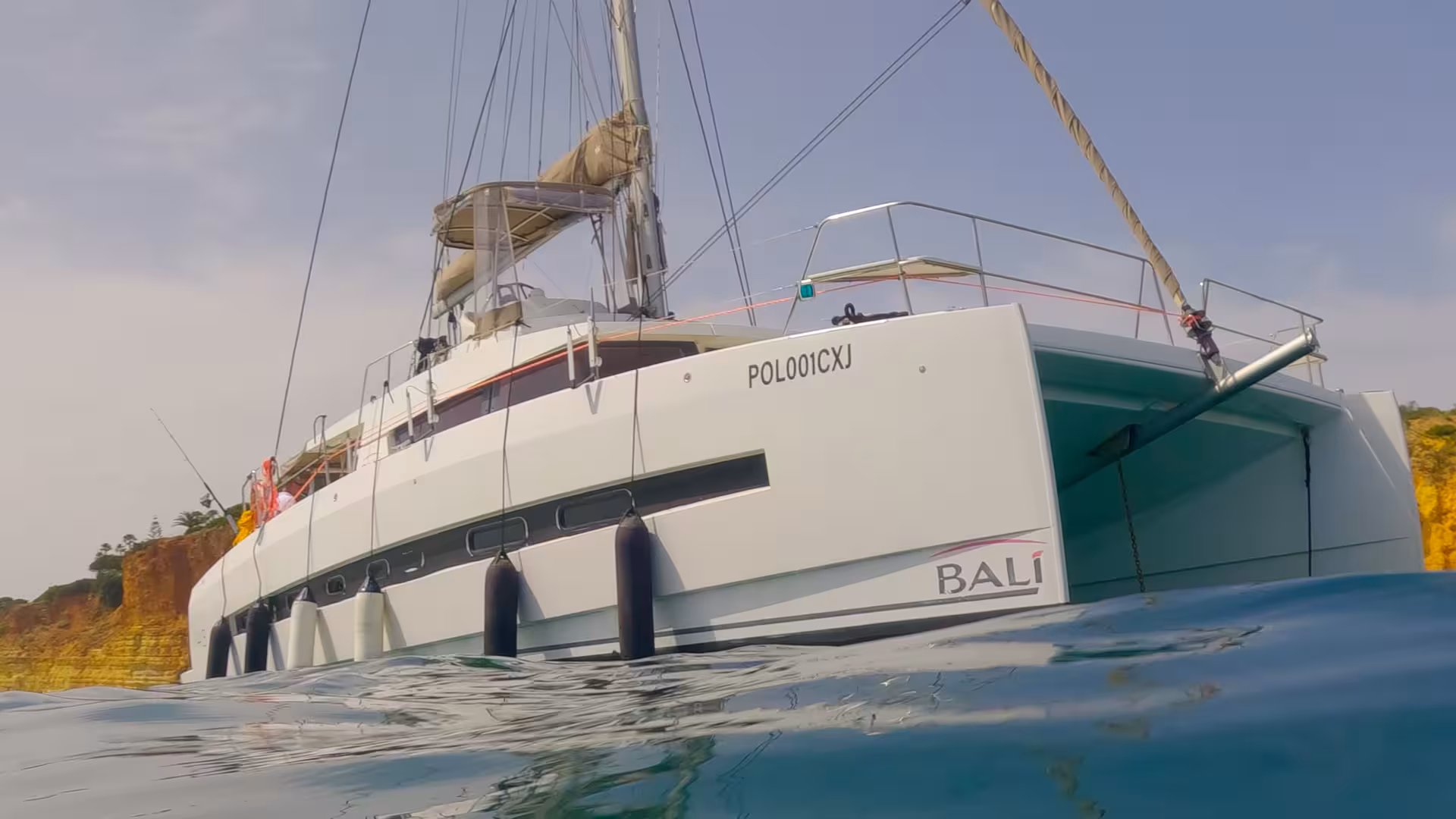 Bali catamaran anchored off Lagos Algarve coast, ideal for a daytime sailing tour with ocean swim stops