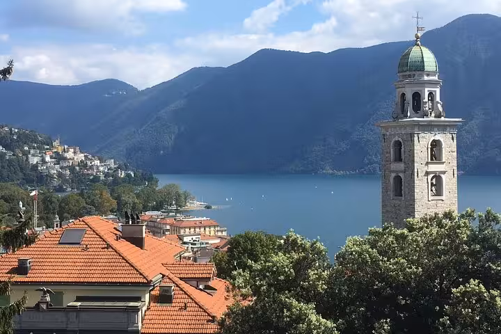 Lake Como view from Bellagio with church bell tower and mountains, highlight of Lugano and lake cruise tour