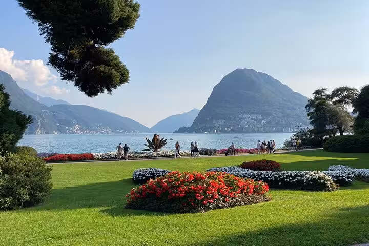 Lakeside gardens on Lake Como with mountain views, scenic stop on Milan to Como Bellagio and Lugano cruise