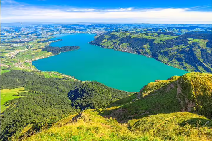 Breathtaking aerial view of Lake Lucerne surrounded by lush green hills, as seen from Mount Rigi.