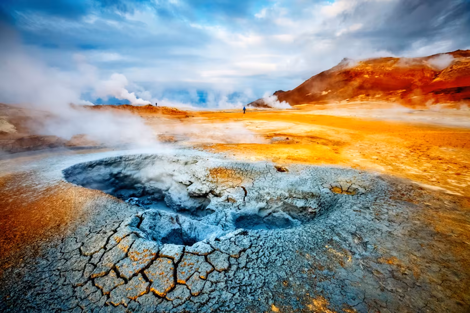 Steaming geothermal mud pools with colorful sulfur deposits at Lake Myvatn, Iceland