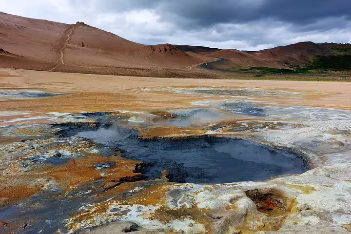 Boiling mud pools and colorful geothermal ground at Hverir near Lake Myvatn, Iceland