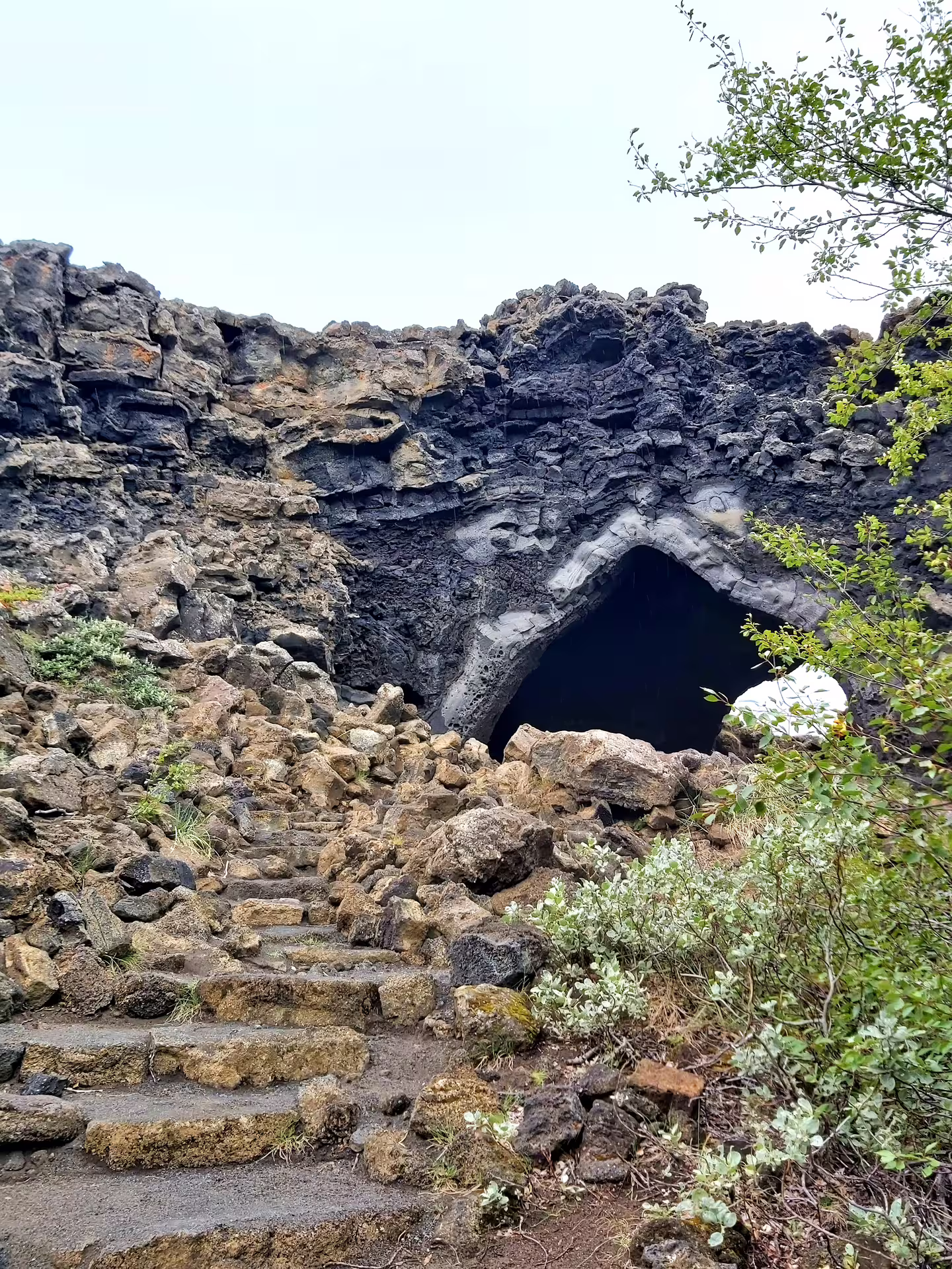 Lava cave entrance with stone steps at Lake Myvatn Iceland