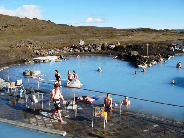 Visitors relaxing in the blue geothermal waters of Lake Myvatn Nature Baths, Iceland