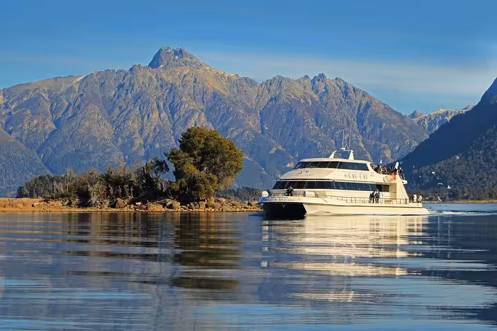 Scenic boat cruise on Lake Nahuel Huapi with mountain views en route to Victoria Island and Arrayanes Forest tour.