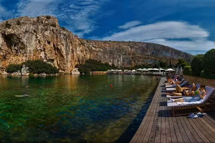 Crystal-clear lagoon and cliffside swim spot on the Athenian Riviera, relaxing summer day trip from Athens