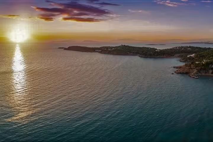 Sunset over the Saronic Gulf along the Athenian Riviera, scenic coastal views on a summer Athens day trip