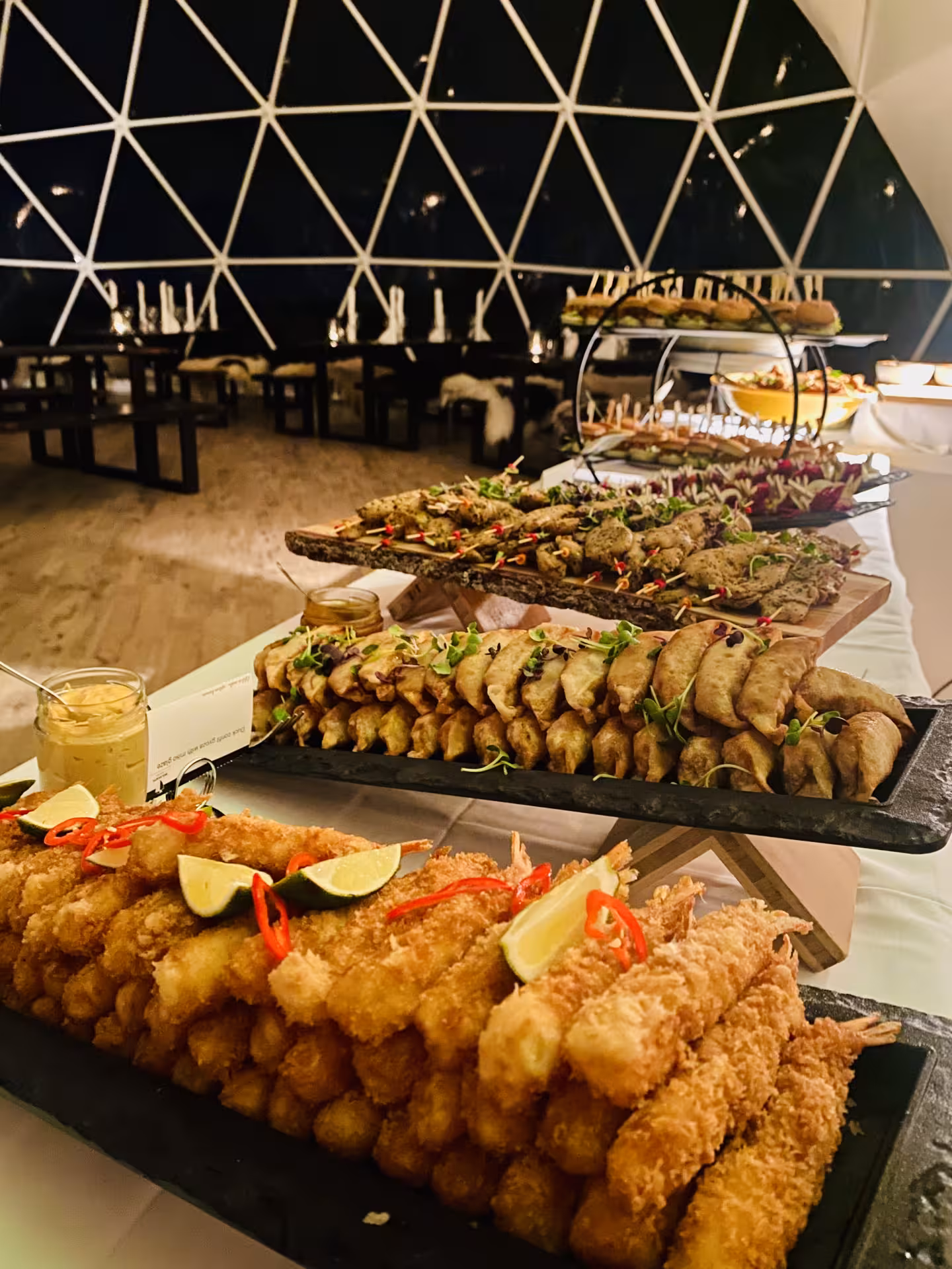 Crispy fried seafood and savory appetizers displayed on a stunning food pairing spread at a lakeside wine tasting event