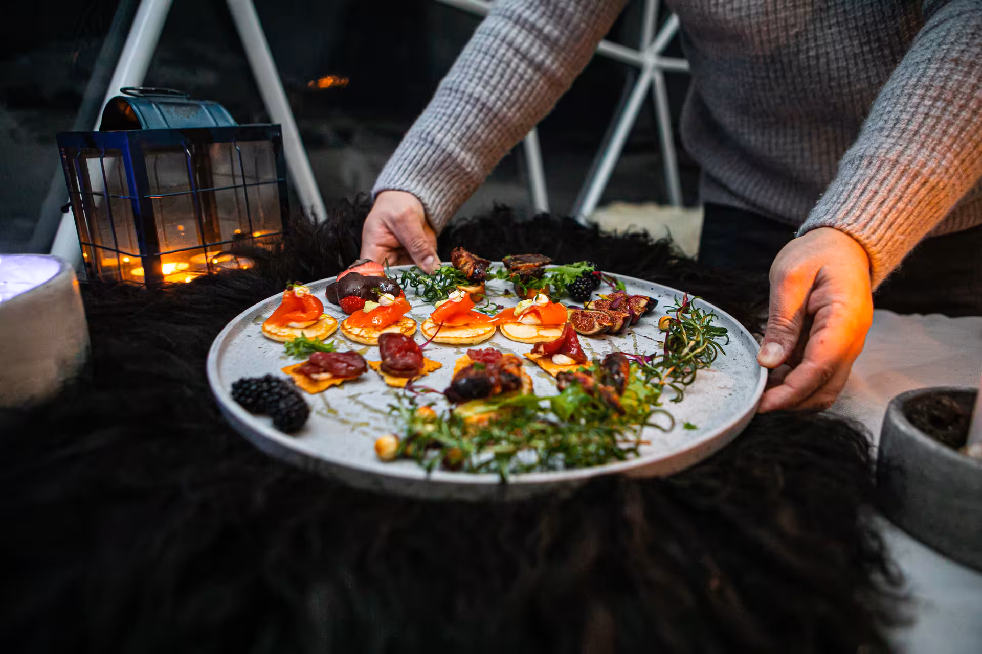 Elegant wine tasting food pairing platter with smoked salmon canapés served lakeside by candlelight