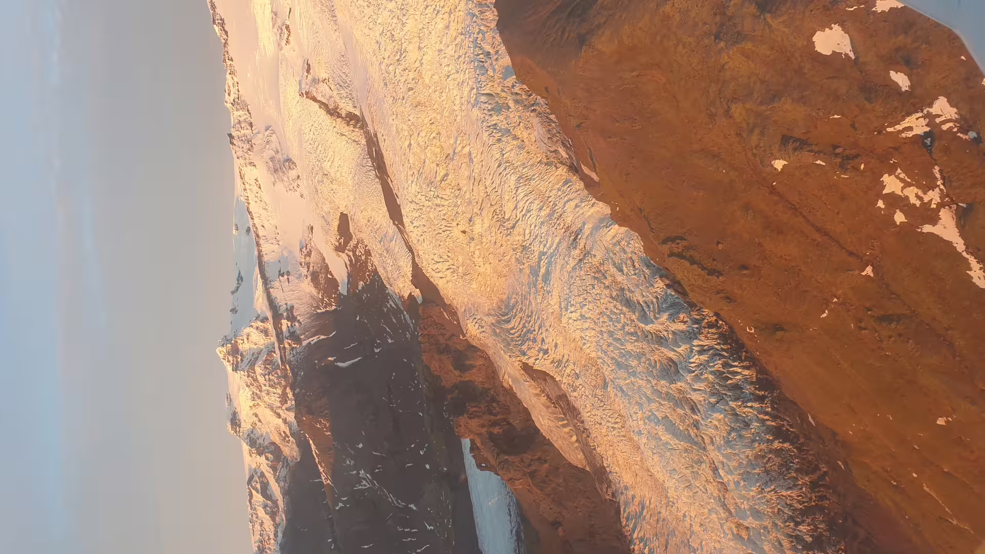 Aerial view of Laki volcanic craters with glacial ice and rust-colored terrain in Iceland