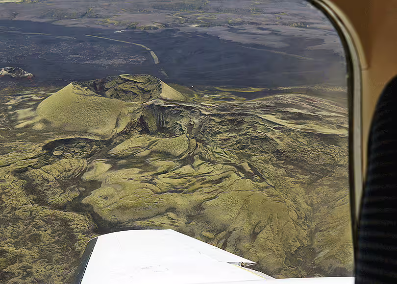 Aerial view of Laki volcanic craters and lava fields in Iceland seen from small aircraft window