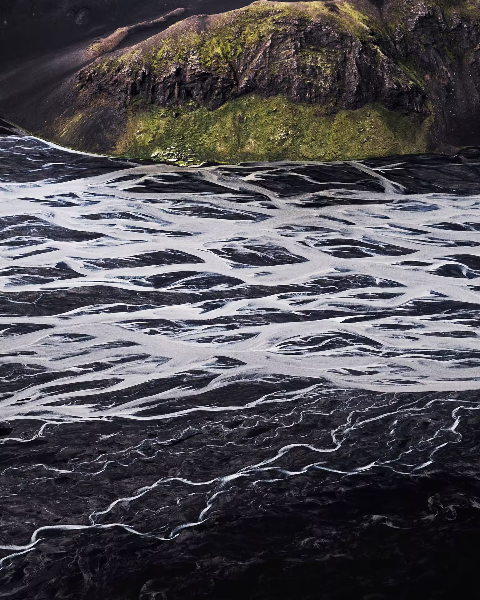 Aerial view of glacial braided river on black volcanic sand near Laki Craters Iceland