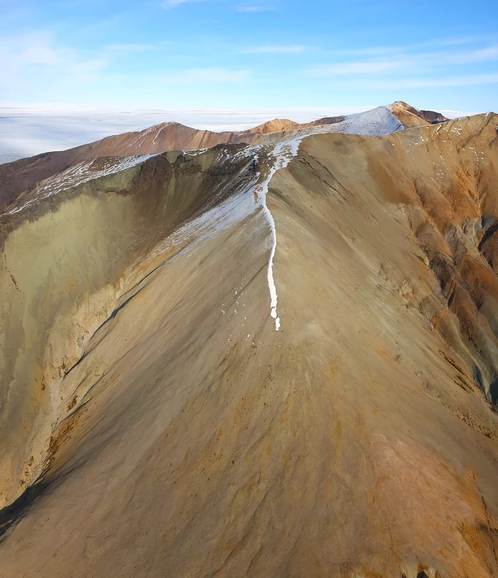 Aerial view of volcanic ridge at Laki Craters Iceland with snow dusting and colorful rhyolite slopes
