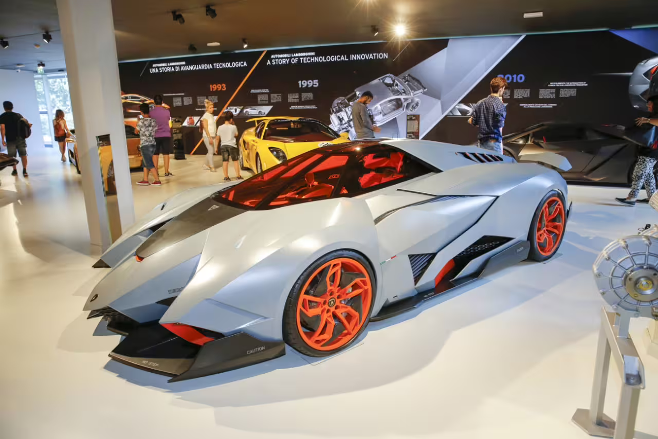 Visitors viewing Lamborghini supercars inside Museo Lamborghini Modena, part of Bologna supercar museum entry